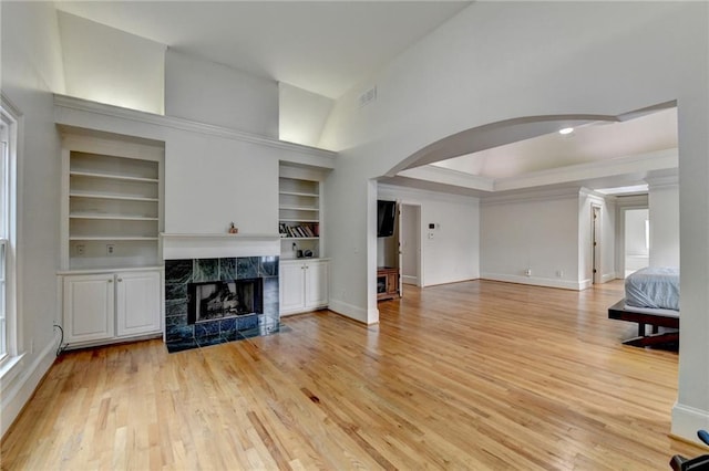 12130 Helleri Holw, Alpharetta, GA 30005 - unfurnished living room with arched walkways, light wood-type flooring, and baseboards