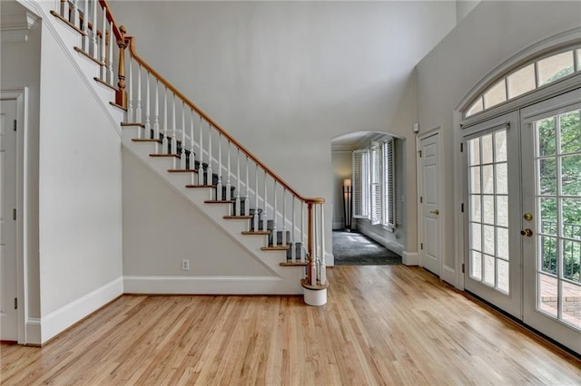 12130 Helleri Holw, Alpharetta, GA 30005 - entryway featuring wood finished floors, arched walkways, stairs, a towering ceiling, and french doors