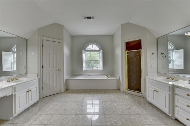 12130 Helleri Holw, Alpharetta, GA 30005 - bathroom with lofted ceiling, a garden tub, a stall shower, two vanities, and tile patterned flooring