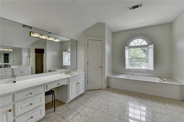 12130 Helleri Holw, Alpharetta, GA 30005 - full bathroom featuring vaulted ceiling, a garden tub, vanity, and tile patterned flooring