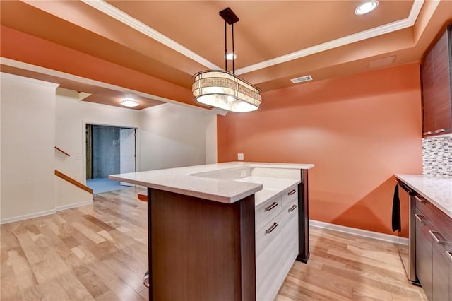 12130 Helleri Holw, Alpharetta, GA 30005 - kitchen featuring light wood-style floors, a tray ceiling, ornamental molding, baseboards, and a kitchen island