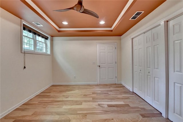 12130 Helleri Holw, Alpharetta, GA 30005 - unfurnished bedroom featuring a raised ceiling, light wood finished floors, a closet, recessed lighting, and crown molding