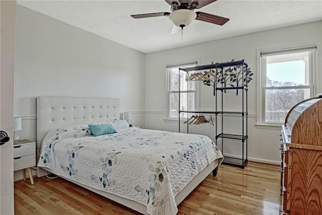 bedroom with light wood-type flooring and ceiling fan