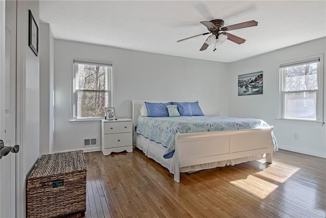 bedroom with ceiling fan and hardwood / wood-style flooring