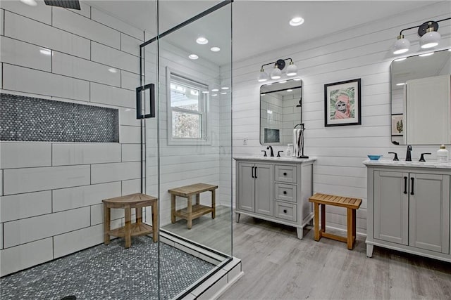 bathroom with vanity, walk in shower, and hardwood / wood-style floors