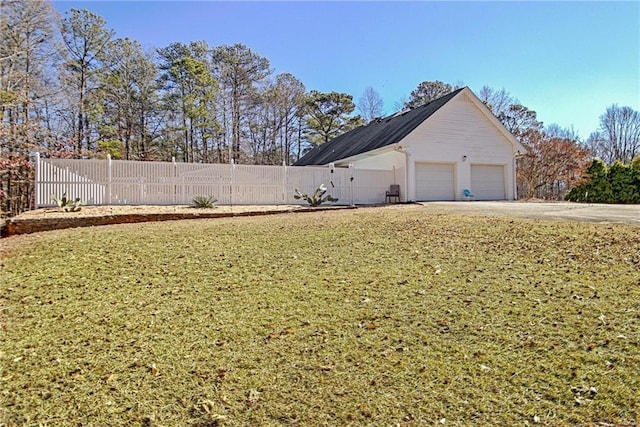 exterior space with a yard and a garage