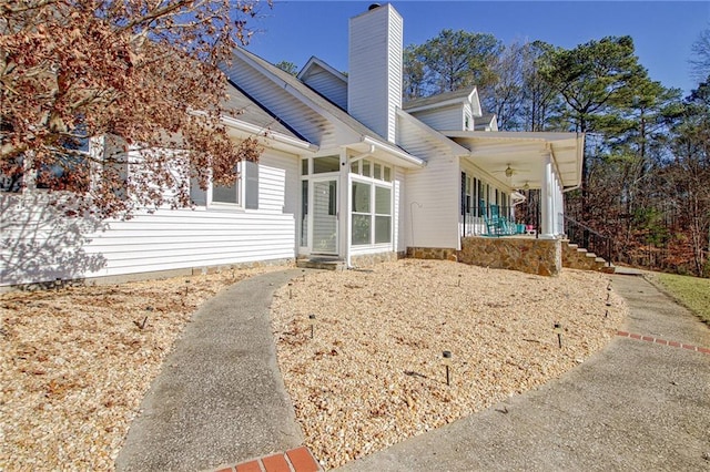 back of property featuring ceiling fan