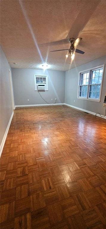 spare room featuring parquet flooring, a textured ceiling, and ceiling fan