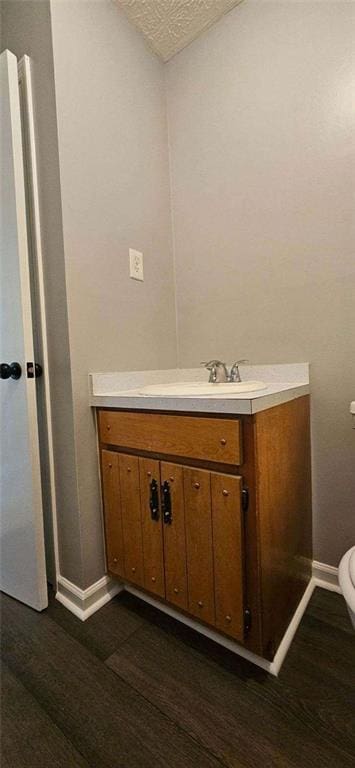 bathroom featuring hardwood / wood-style floors, vanity, and toilet