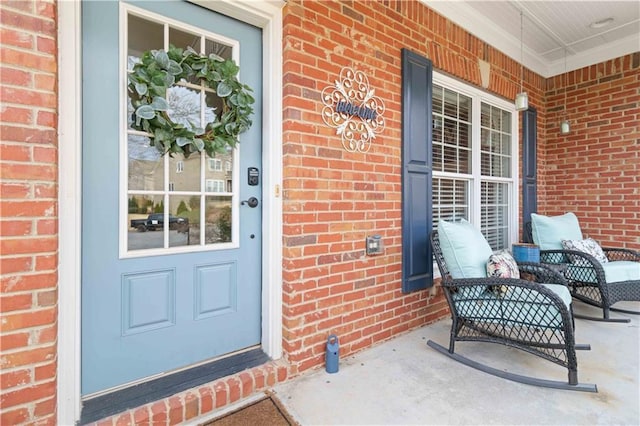 doorway to property featuring brick siding