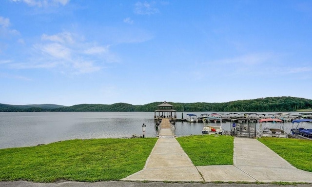 view of dock featuring a yard and a water view