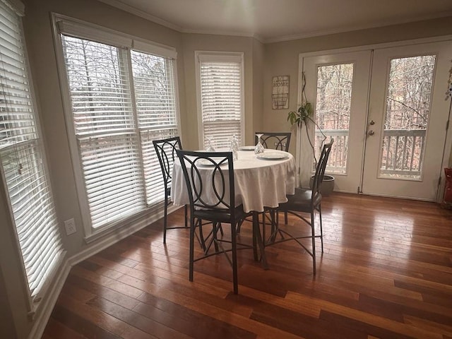 kitchen featuring french doors, stainless steel appliances, wood-type flooring, a kitchen island, and ornamental molding