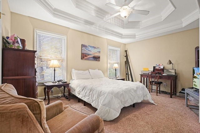 carpeted bedroom featuring a tray ceiling, ceiling fan, and crown molding