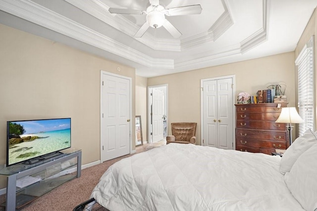 bedroom with carpet flooring, a raised ceiling, ceiling fan, and ornamental molding