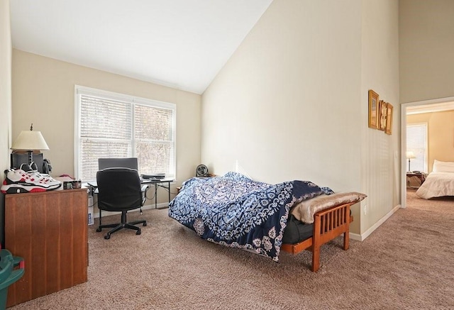 bedroom with carpet flooring and high vaulted ceiling