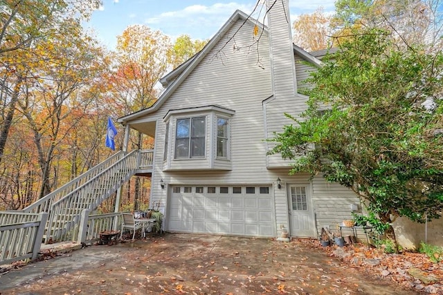 rear view of house featuring a garage