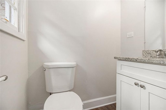 3294 Renault Rd SE, Atlanta, GA 30354 - bathroom featuring baseboards, toilet, vanity, and wood finished floors
