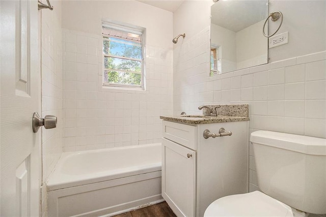3294 Renault Rd SE, Atlanta, GA 30354 - full bath with tile walls, toilet, vanity, shower / tub combination, and wood finished floors