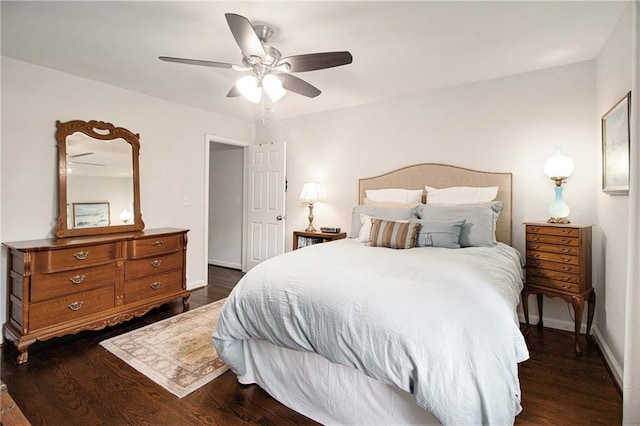 bedroom with dark hardwood / wood-style flooring and ceiling fan