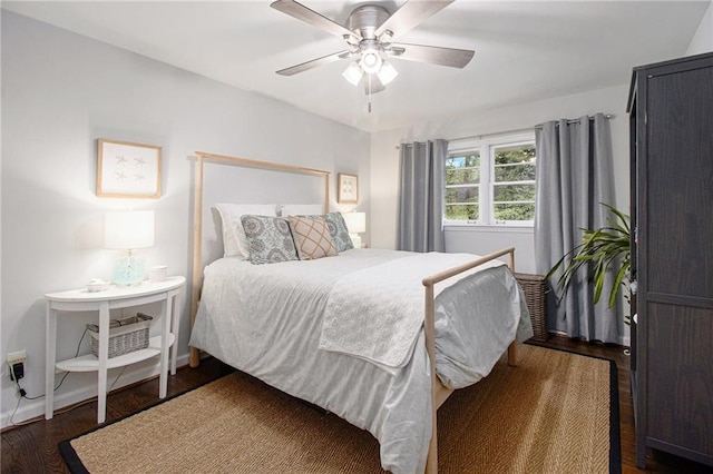 bedroom featuring ceiling fan and dark hardwood / wood-style floors