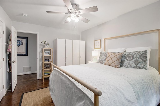 bedroom with ceiling fan and dark wood-type flooring