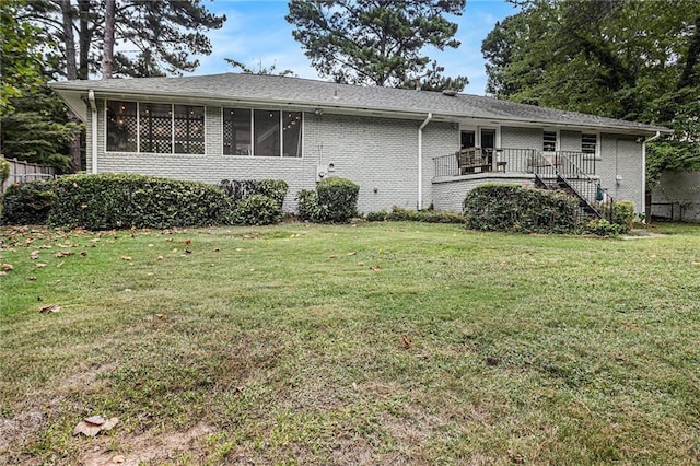 view of front facade featuring a deck and a front lawn