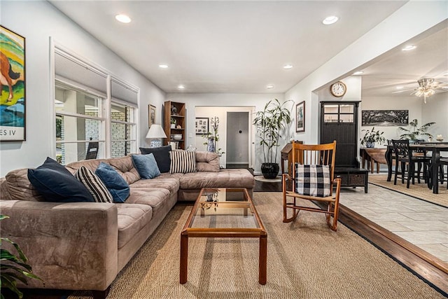 living room featuring light hardwood / wood-style flooring and ceiling fan