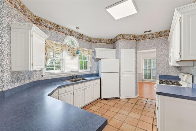 2866 Wynford Dr SW, Marietta, GA 30064 - kitchen featuring white appliances, wallpapered walls, dark countertops, and white cabinets