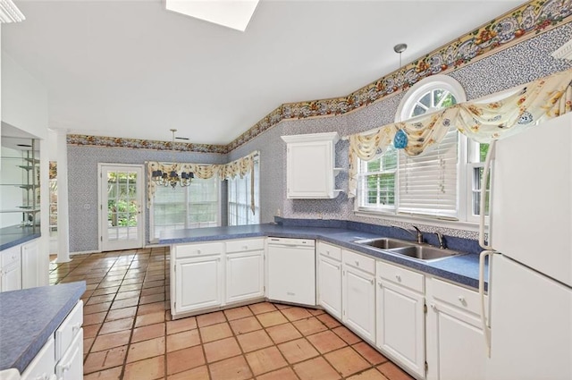 2866 Wynford Dr SW, Marietta, GA 30064 - kitchen featuring white appliances, wallpapered walls, light tile patterned floors, dark countertops, and white cabinetry
