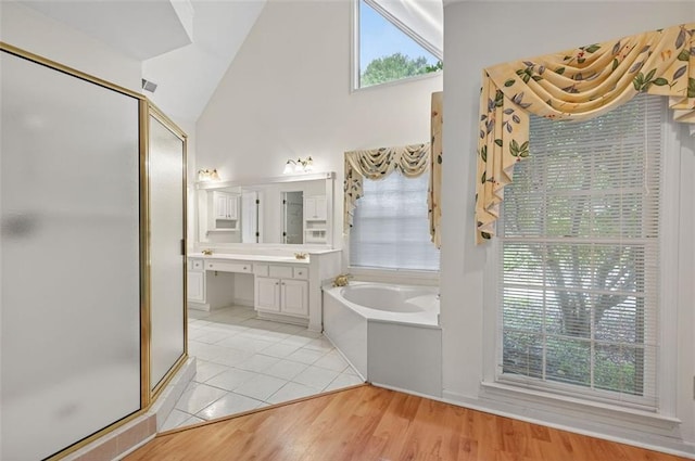 2866 Wynford Dr SW, Marietta, GA 30064 - bathroom with a shower stall, vanity, a bath, tile patterned floors, and high vaulted ceiling