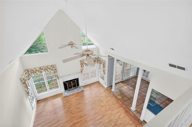 2866 Wynford Dr SW, Marietta, GA 30064 - unfurnished living room with ceiling fan, high vaulted ceiling, wood finished floors, and a fireplace with raised hearth