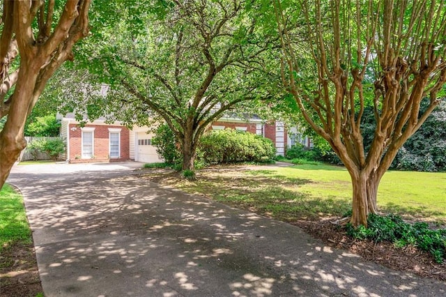 2866 Wynford Dr SW, Marietta, GA 30064 - obstructed view of property with brick siding, driveway, an attached garage, and a front yard