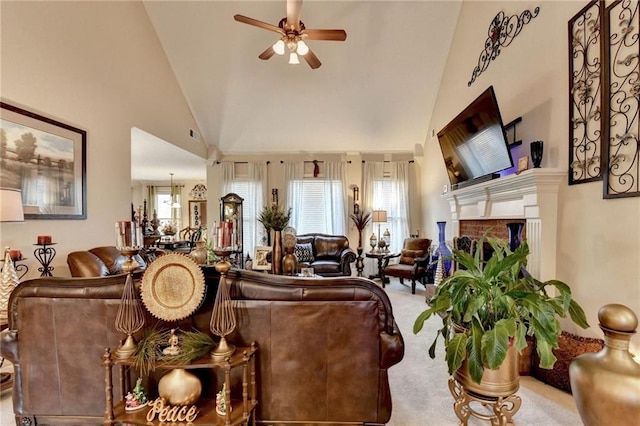 carpeted living room with a fireplace, high vaulted ceiling, and ceiling fan