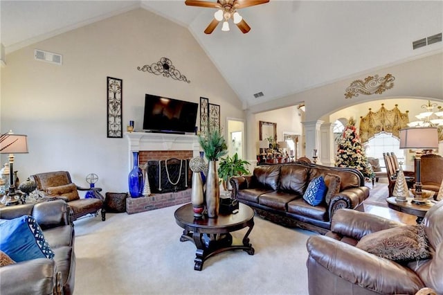 carpeted living room featuring ceiling fan, high vaulted ceiling, and a brick fireplace