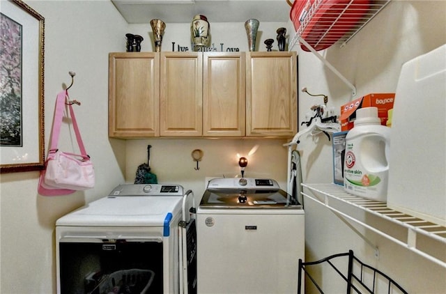 laundry area with cabinets and separate washer and dryer