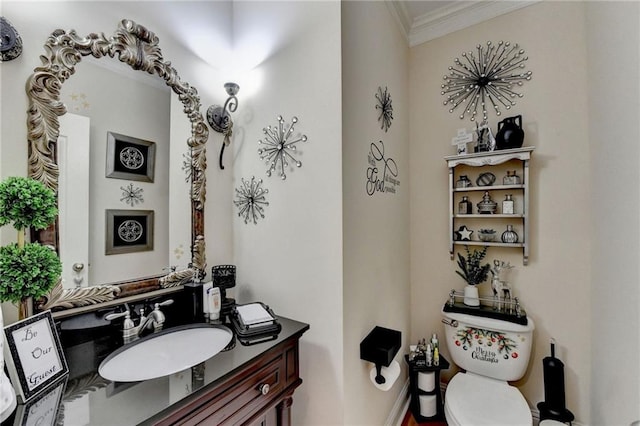 bathroom with vanity, toilet, and ornamental molding