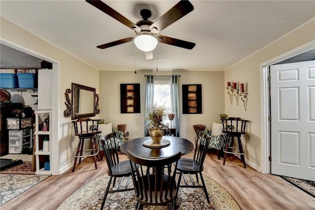 dining room featuring light hardwood / wood-style floors and ceiling fan