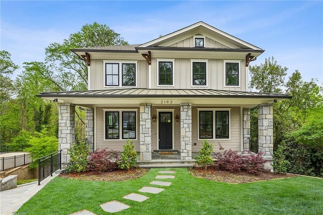2193 Virginia Pl NE, Atlanta, GA 30305 - view of front facade with fence, a standing seam roof, a front lawn, and covered porch