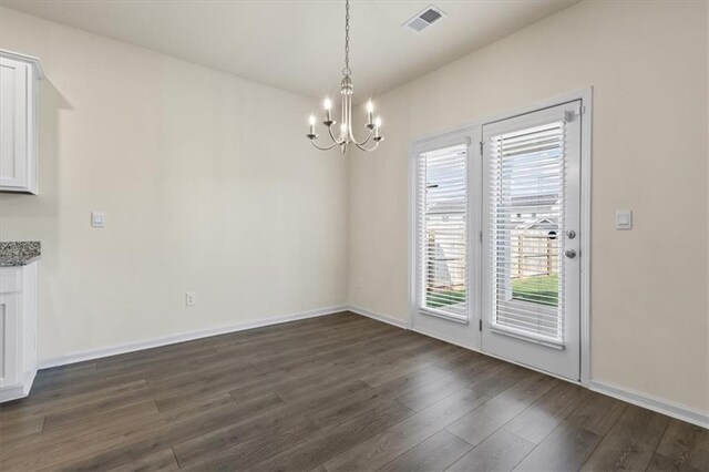 2296 Waycross Ln, Dacula, GA 30019 - unfurnished dining area with a chandelier, dark wood finished floors, and baseboards