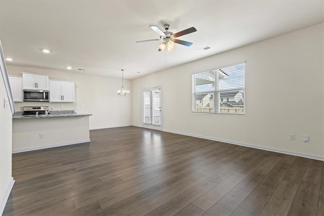 2296 Waycross Ln, Dacula, GA 30019 - unfurnished living room featuring a chandelier, a ceiling fan, recessed lighting, dark wood finished floors, and baseboards