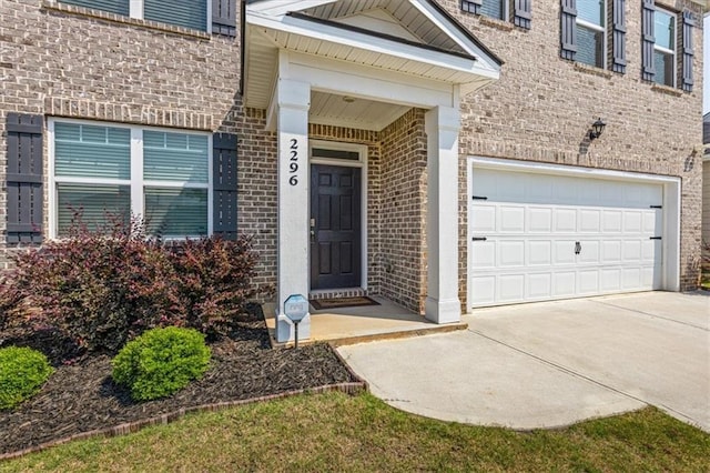 2296 Waycross Ln, Dacula, GA 30019 - property entrance with brick siding, driveway, and an attached garage