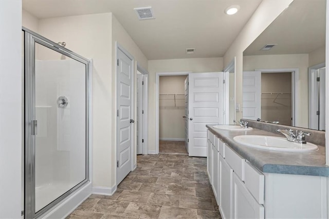 2296 Waycross Ln, Dacula, GA 30019 - full bathroom with baseboards, a shower stall, a spacious closet, double vanity, and stone finish floors