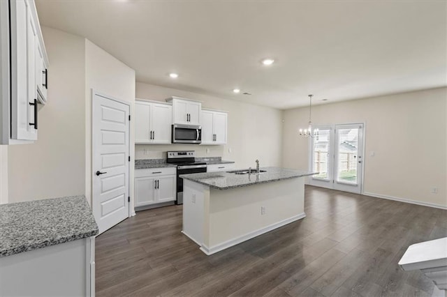 2296 Waycross Ln, Dacula, GA 30019 - kitchen featuring appliances with stainless steel finishes, a sink, dark wood finished floors, a chandelier, and white cabinets
