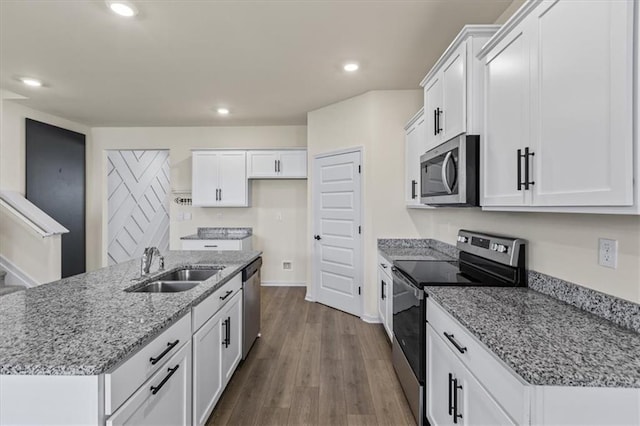 2296 Waycross Ln, Dacula, GA 30019 - kitchen with appliances with stainless steel finishes, a sink, white cabinetry, light stone counters, and recessed lighting