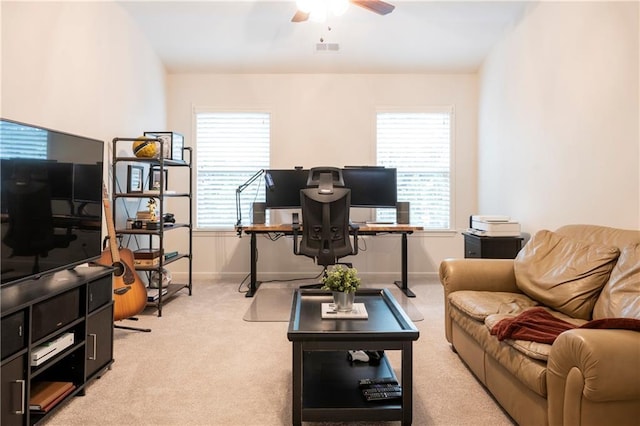 living room with a ceiling fan, baseboards, visible vents, and light carpet