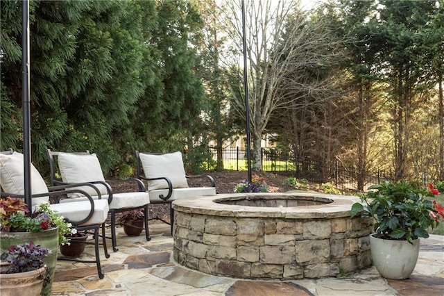 view of patio / terrace featuring fence and an outdoor fire pit