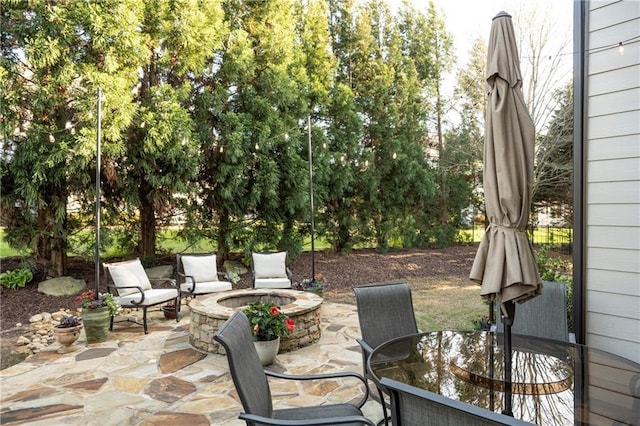 view of patio / terrace featuring outdoor dining space and an outdoor fire pit