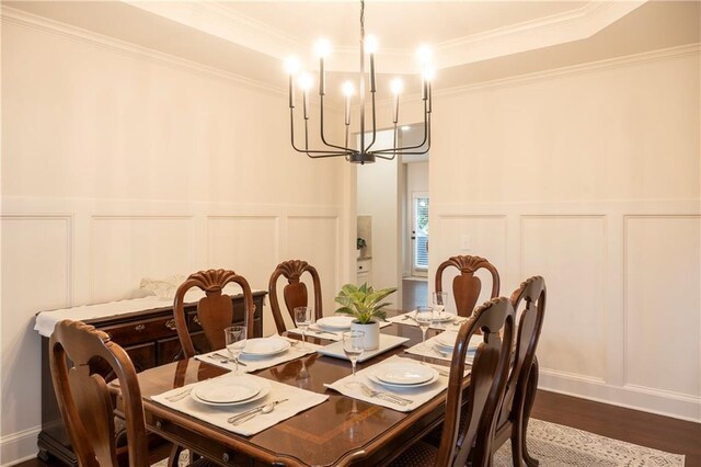 4025 Toulon Ln, Cumming, GA 30040 - dining area with a decorative wall, a chandelier, crown molding, dark wood finished floors, and a wainscoted wall