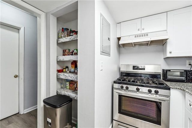 kitchen featuring white cabinets, light stone counters, hardwood / wood-style flooring, and stainless steel range with gas stovetop