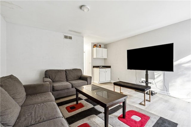 living room with light hardwood / wood-style flooring